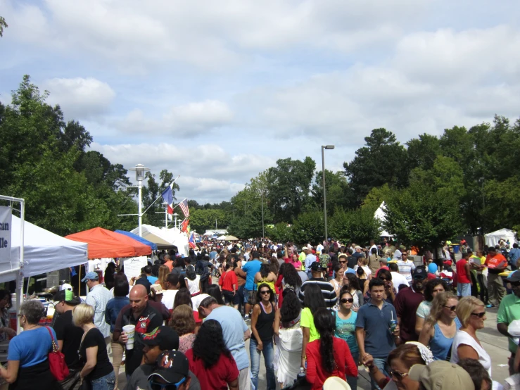 a large group of people standing around and eating some food