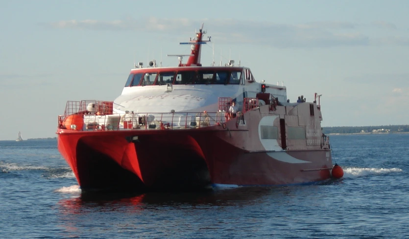 a ship is passing through the water on its way to shore