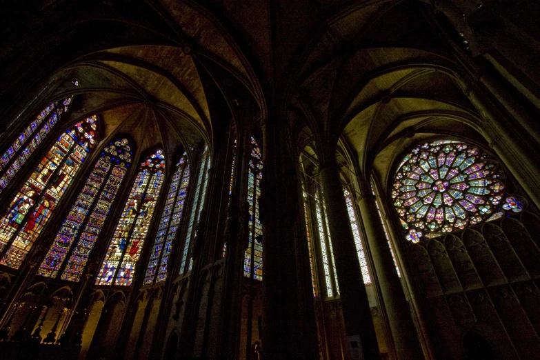 the inside of a cathedral with multiple colored glass