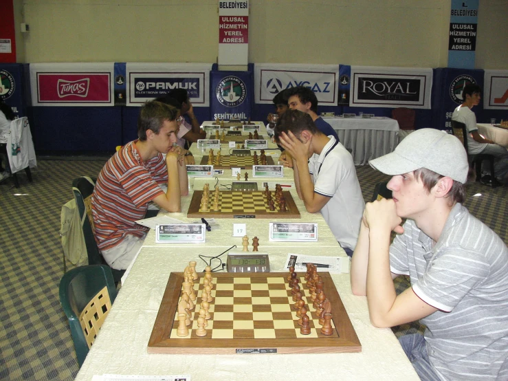 two men playing chess in a chess hall