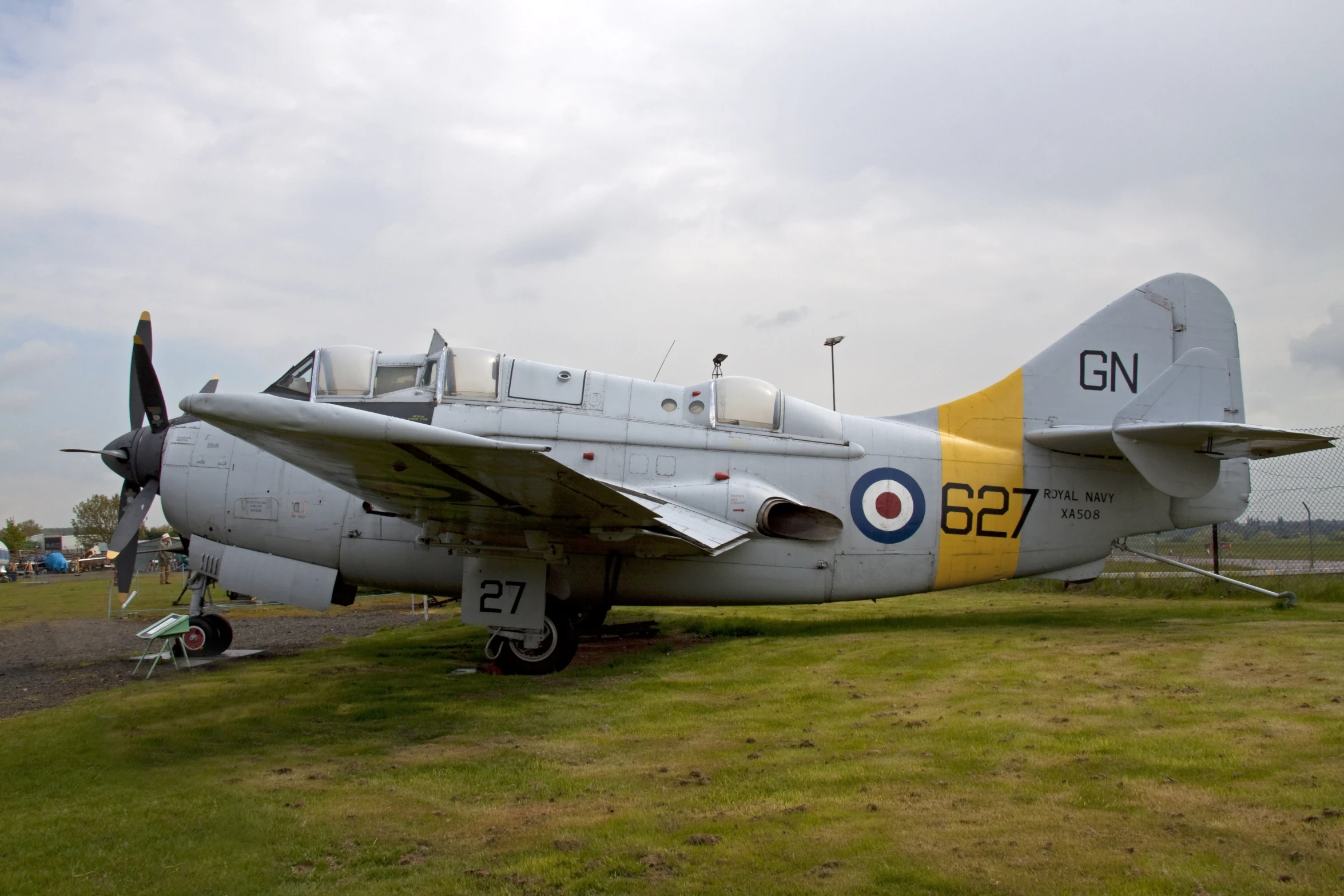 an airplane parked on top of a field of grass