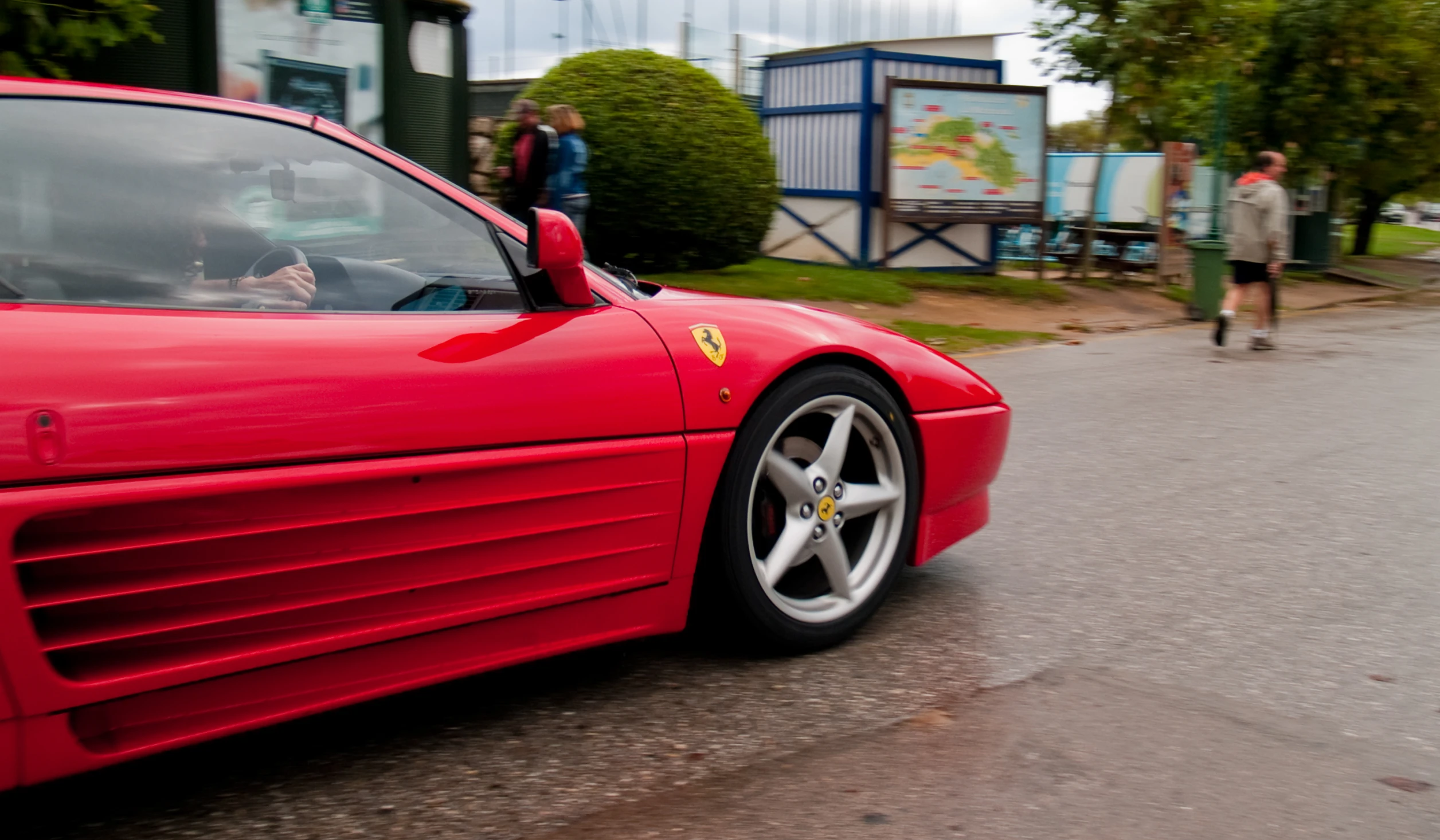 a red sports car is parked on the street