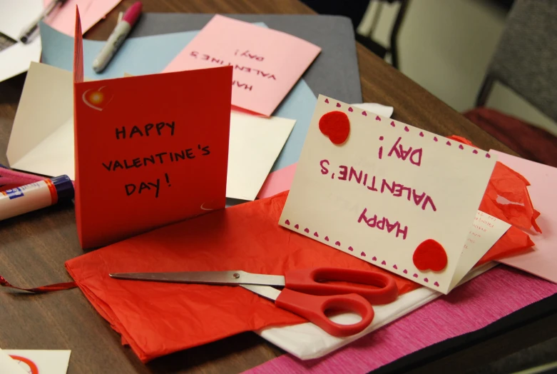 this is a valentine's day workbench with paper and scissors