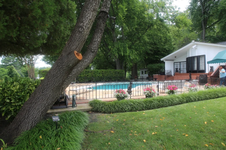 a pool and deck with outdoor furniture is shown