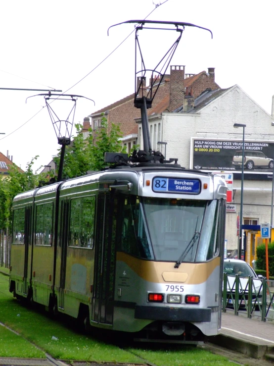 a yellow and silver train sitting on the tracks