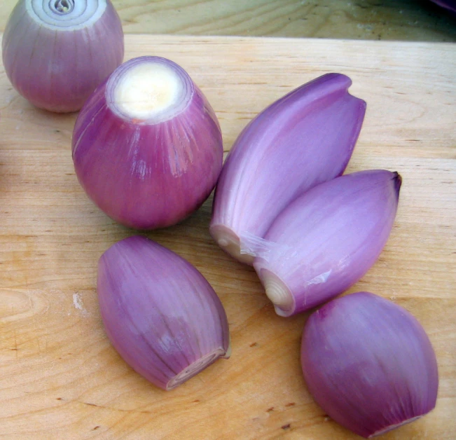 four onions are shown on a  board