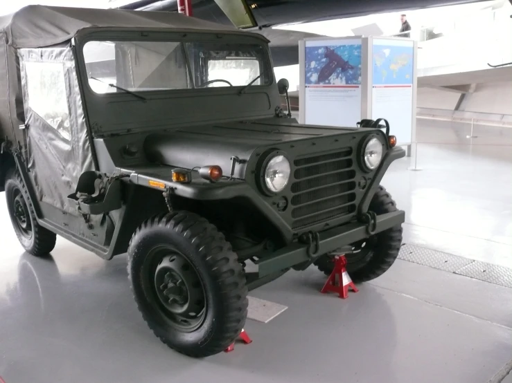 a large green vehicle sitting in a hangar