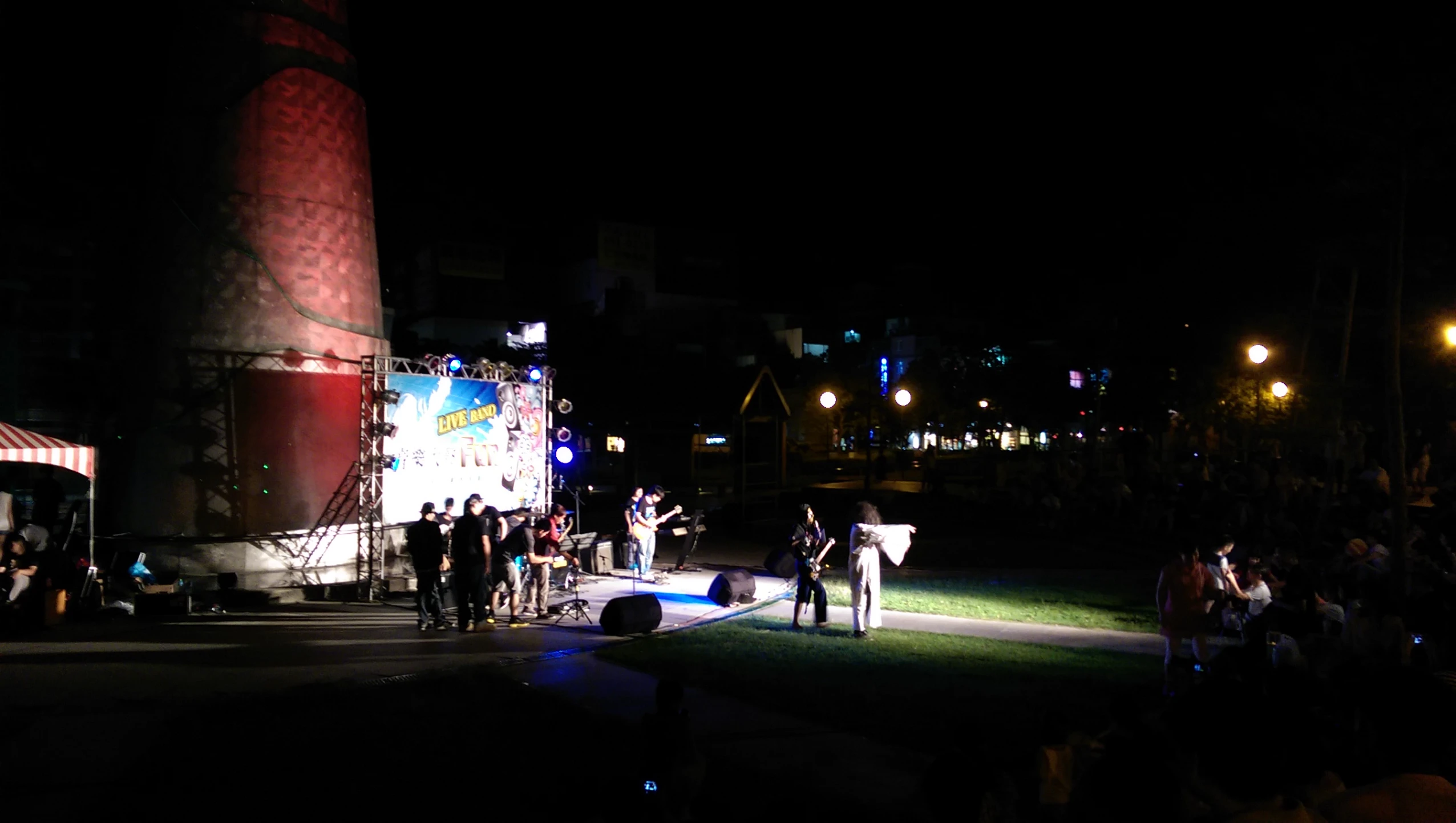 people standing on the street watching the show