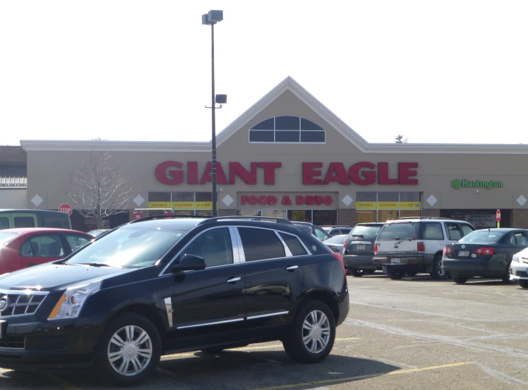 a large garage and a store with many parked cars