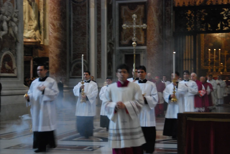 a group of priests walking down the aisle