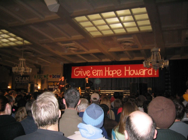 people looking up and in a crowded building