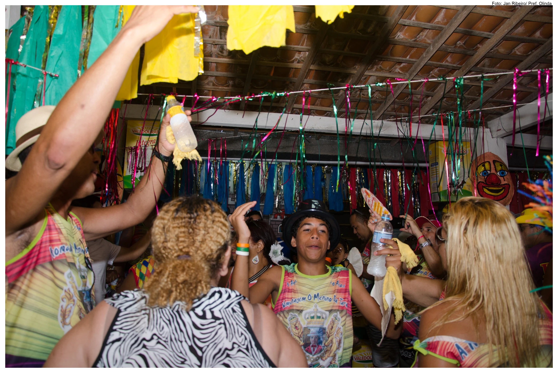 woman dressed in colorful clothing having fun with a string of string garland