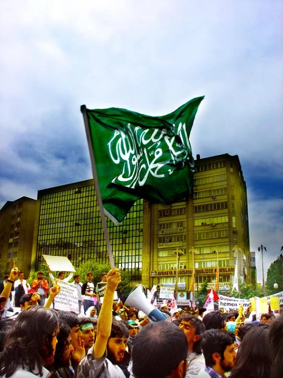 some people standing in front of a building holding flags