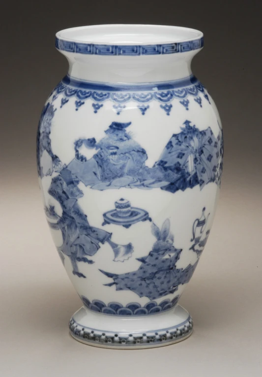 a large blue and white vase on top of a table