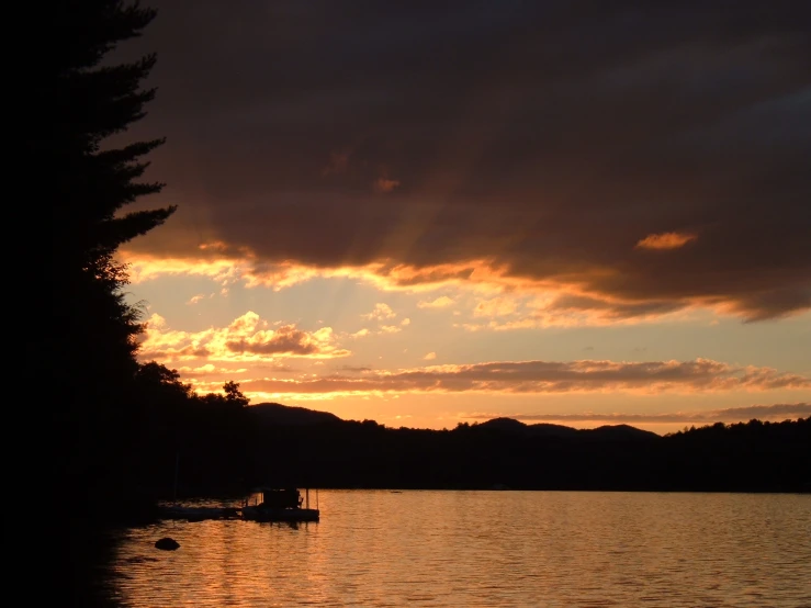 a beautiful sunset over a lake in the mountains