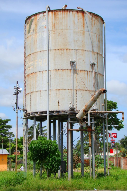 a large water tank near an electrical pole