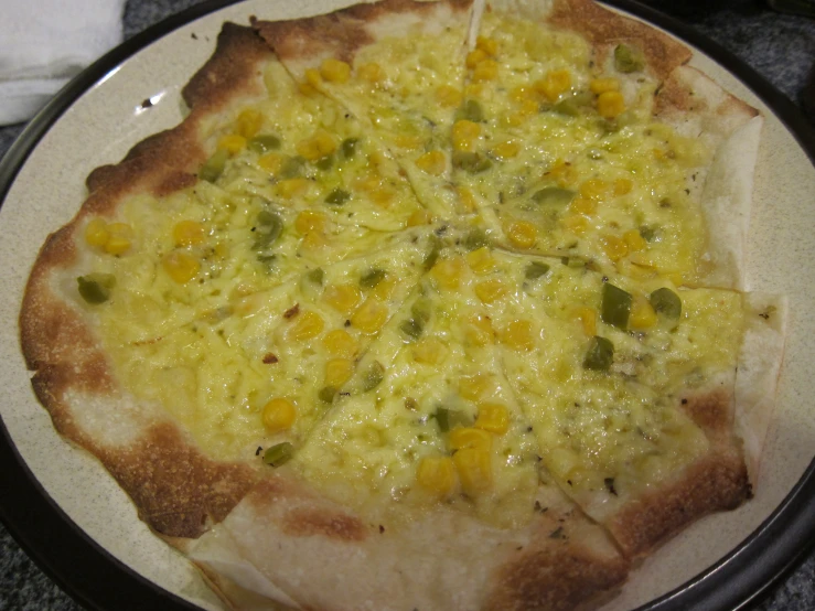 a thin crust pizza with corn, cheese and green onions