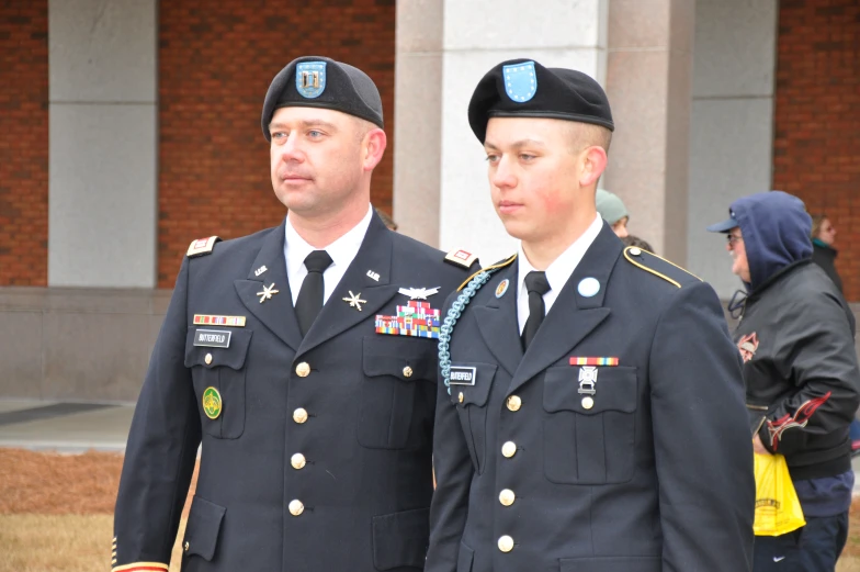 two men in uniforms walking next to each other