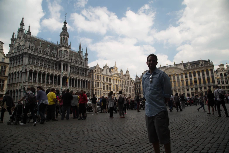 a man in a street surrounded by buildings