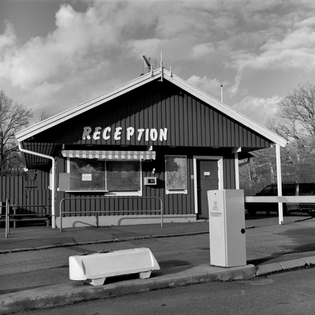 a black and white po with an old sign for reception