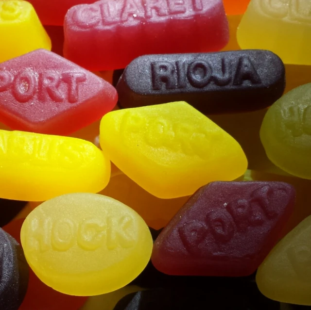close up view of colorful candies with text