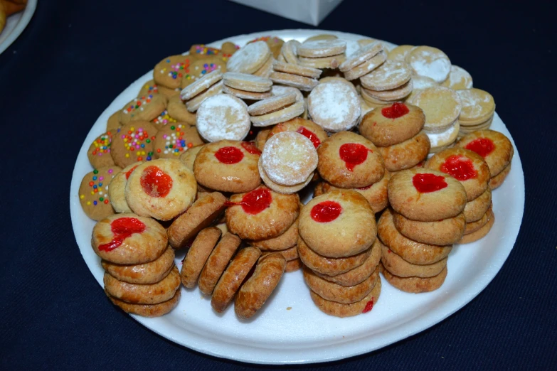 a plate full of cookies, marshmallows and sugar cookies