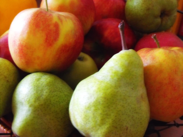 a basket full of assorted apples and pears