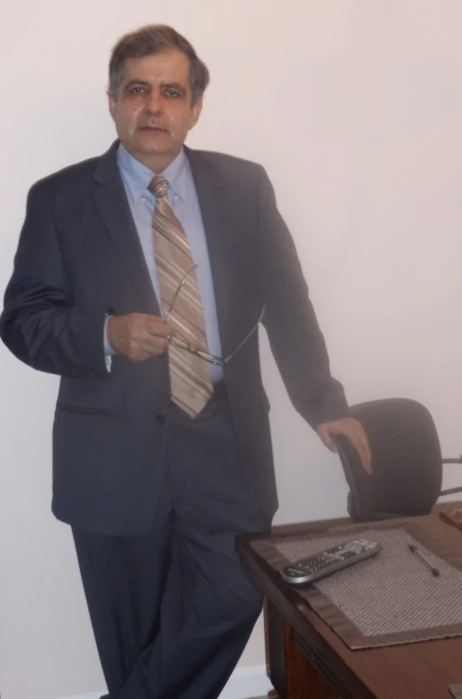 a business man in suit jacket and tie holding a tie and pointing at the side