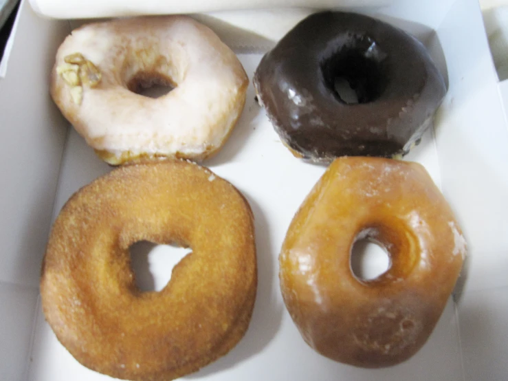 a variety of donuts sitting in a box