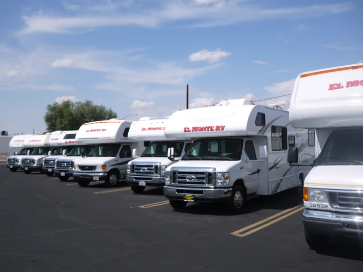 a group of small rvs parked next to each other in a parking lot