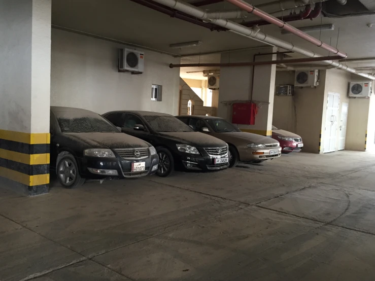 three cars parked in an empty garage