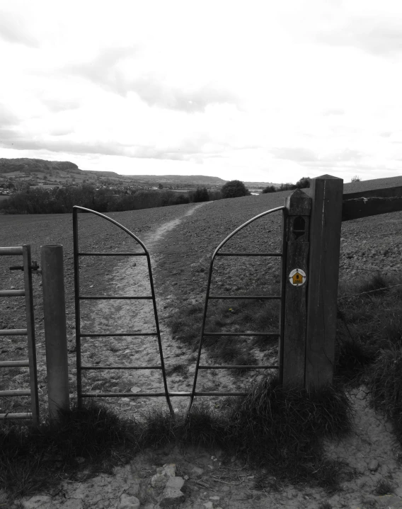 two gates in the grass behind which one of them has a rock in it