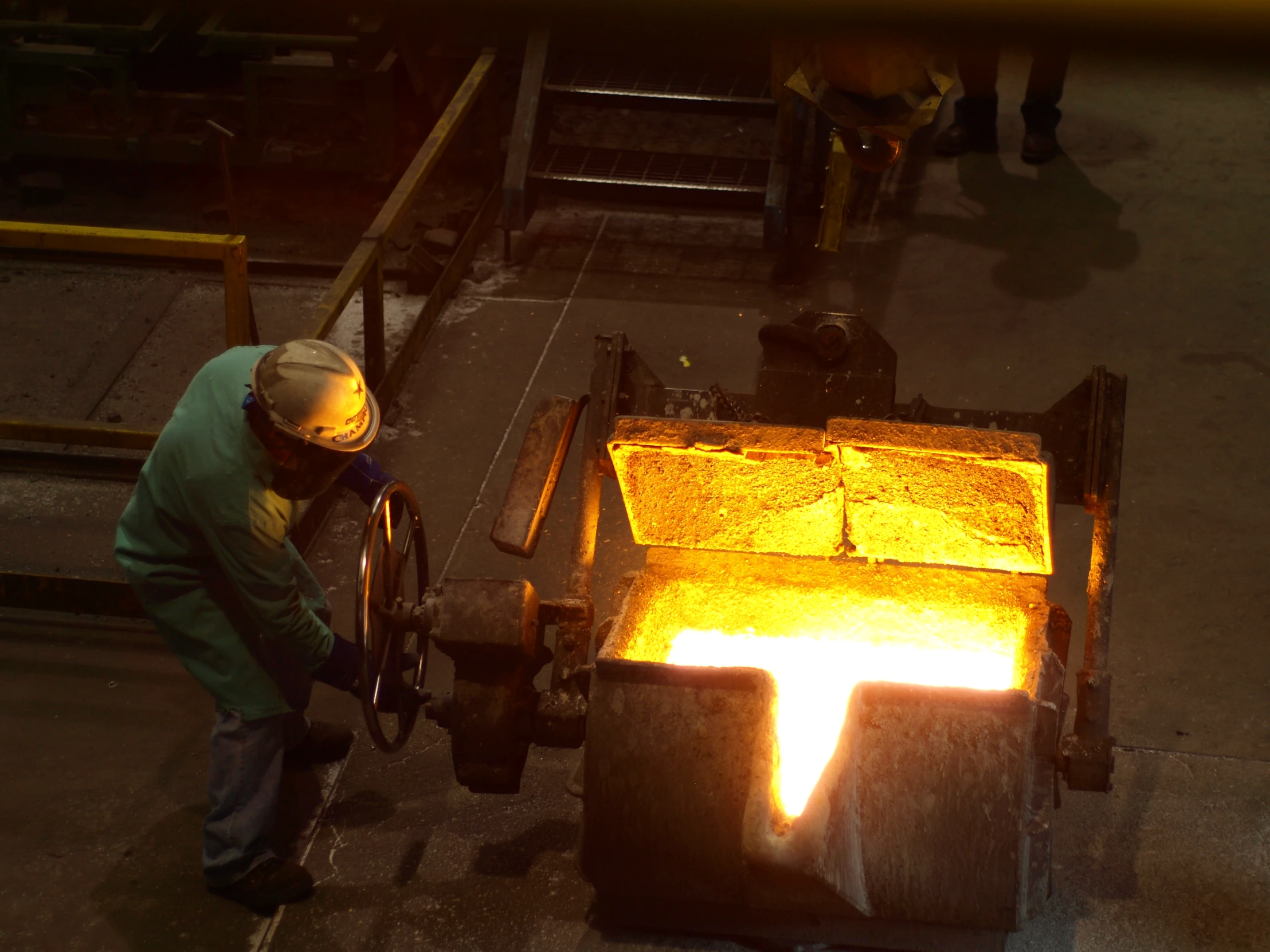 a man in safety clothing welding on a machine