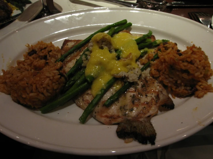 chicken and asparagus on a plate with brown rice