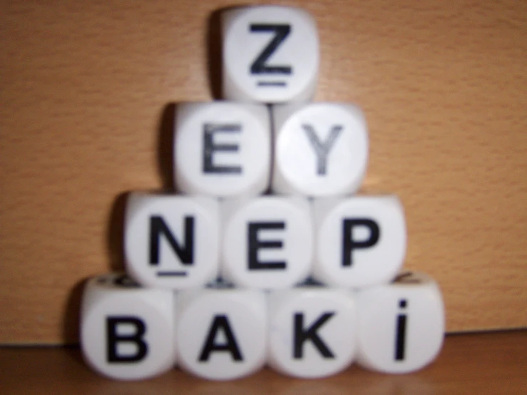 the scrabbles spelling the word'ey nep baki'on a table