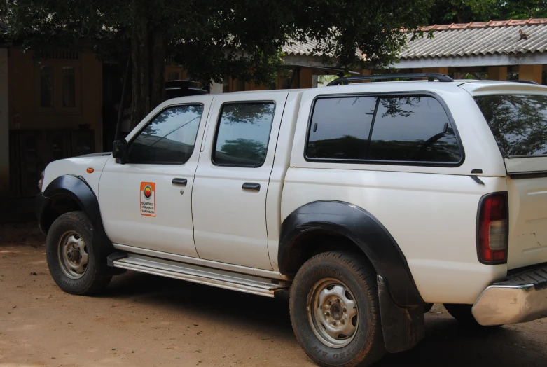 white pick up truck parked in front of brick building