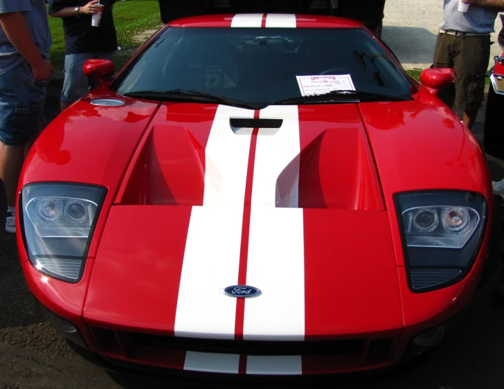 red and white car with stripe painted on the hood