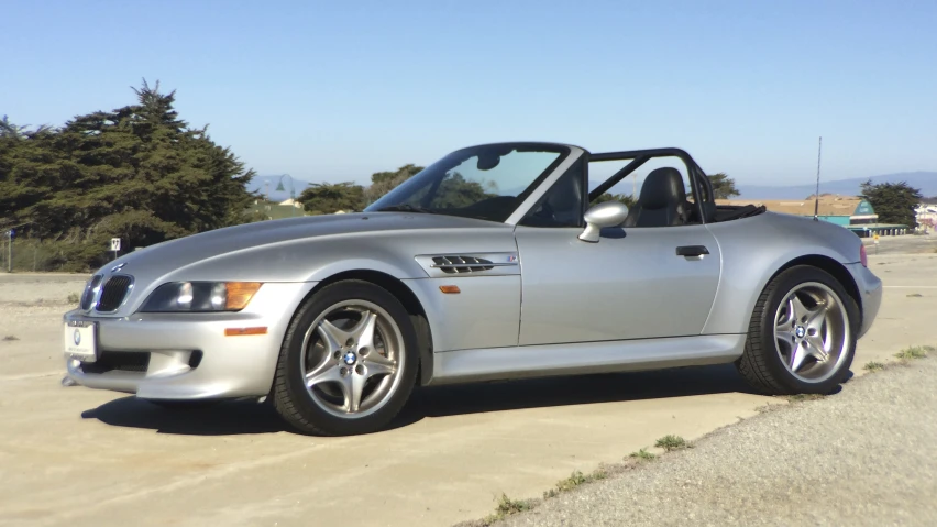 the silver sports car is parked in a parking lot