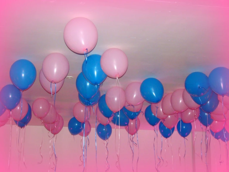 many balloons in rows hanging from the ceiling