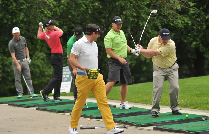 golfers practice their swing during an outdoor golf outing