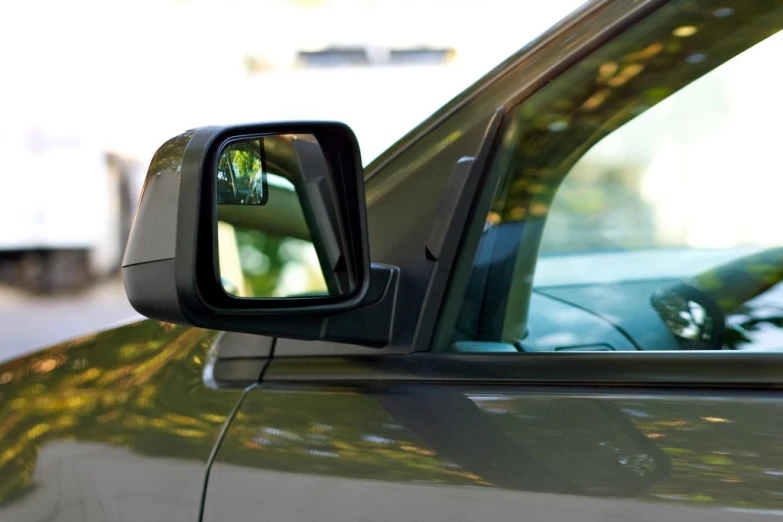 a side mirror on a car reflecting a picture