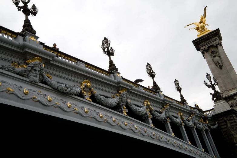 a view of an ornate metal structure near a clock tower