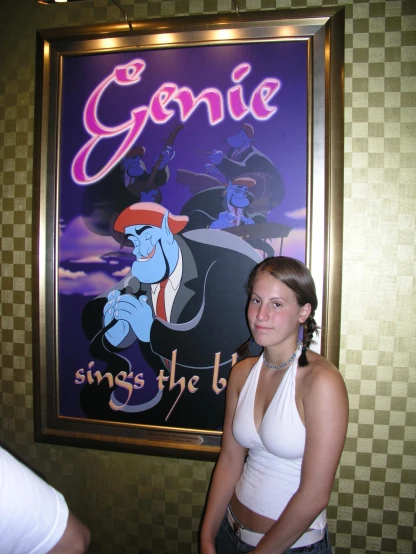 a girl is standing next to a poster