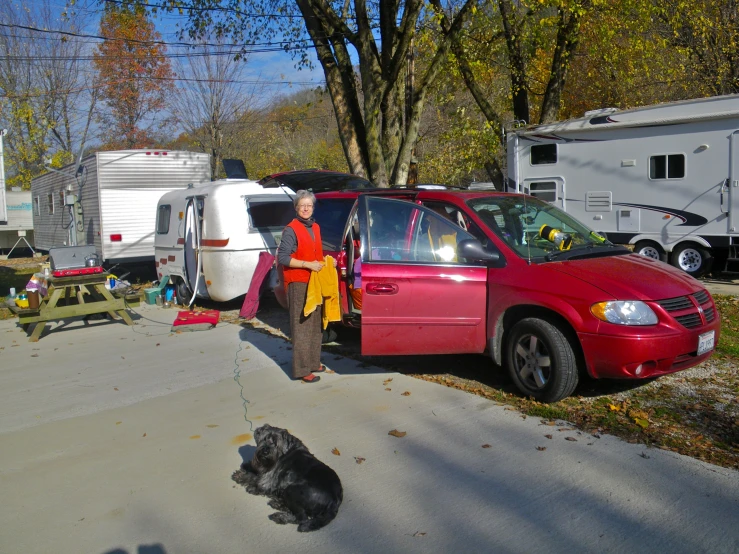 the red van is parked on the side of the road