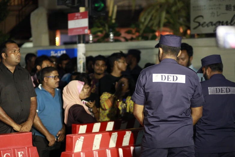 several police officers stand in a line next to barriers