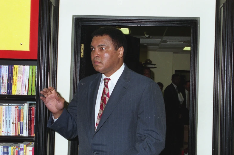 a man in a suit and tie standing up