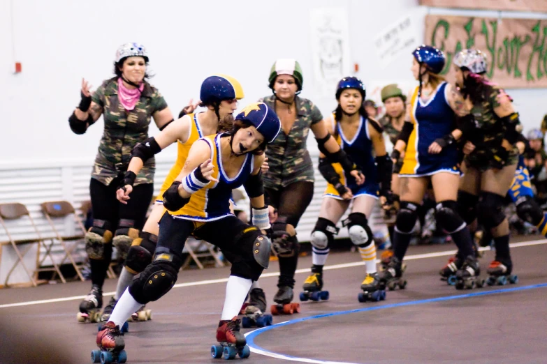 several women roller skating in an indoor arena