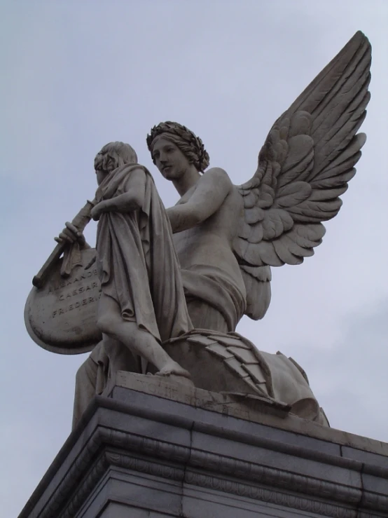 there is a statue of an angel holding a jug and wearing headphones