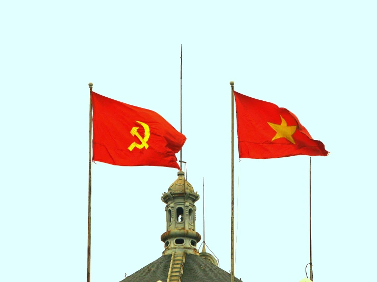 two chinese flags flying next to each other