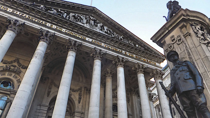 a large building with columns and statues on the front